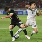 Indonesia U-19 player Eizar Jaco (right) challenges an Australia U-19 player for possession during the AFF U-19