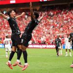 Jonathan David celebrates with teammate Stephen Eustáquio