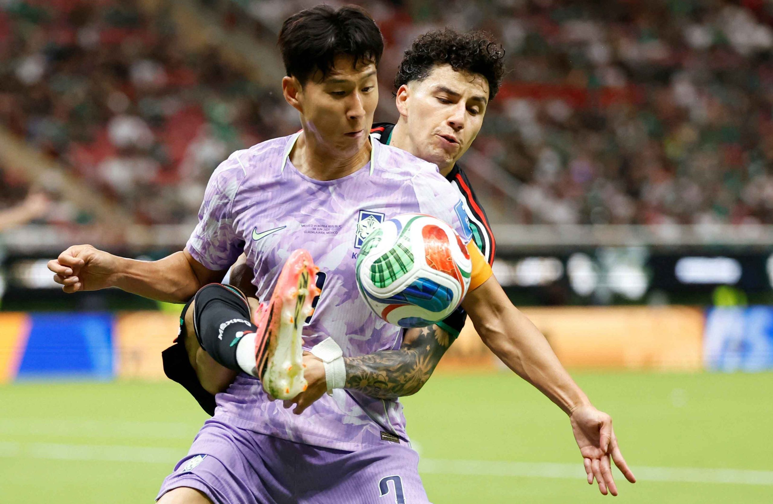 Jorge Sanchez battles for possession with Son Heung-min