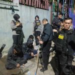 teenagers are detained by police officers
