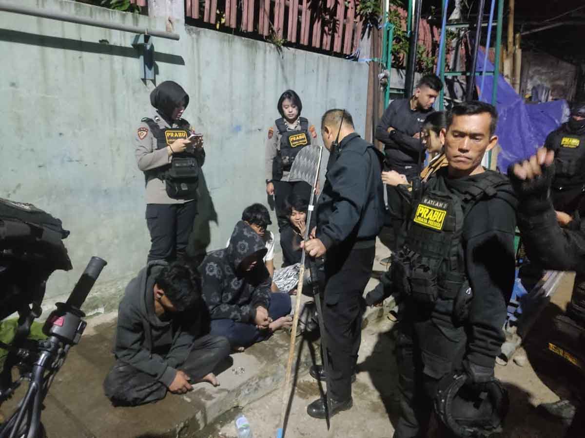 teenagers are detained by police officers