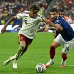 Lamine Yamal (left) attempts to get past France defender Theo Hernandez