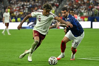 Lamine Yamal (left) attempts to get past France defender Theo Hernandez