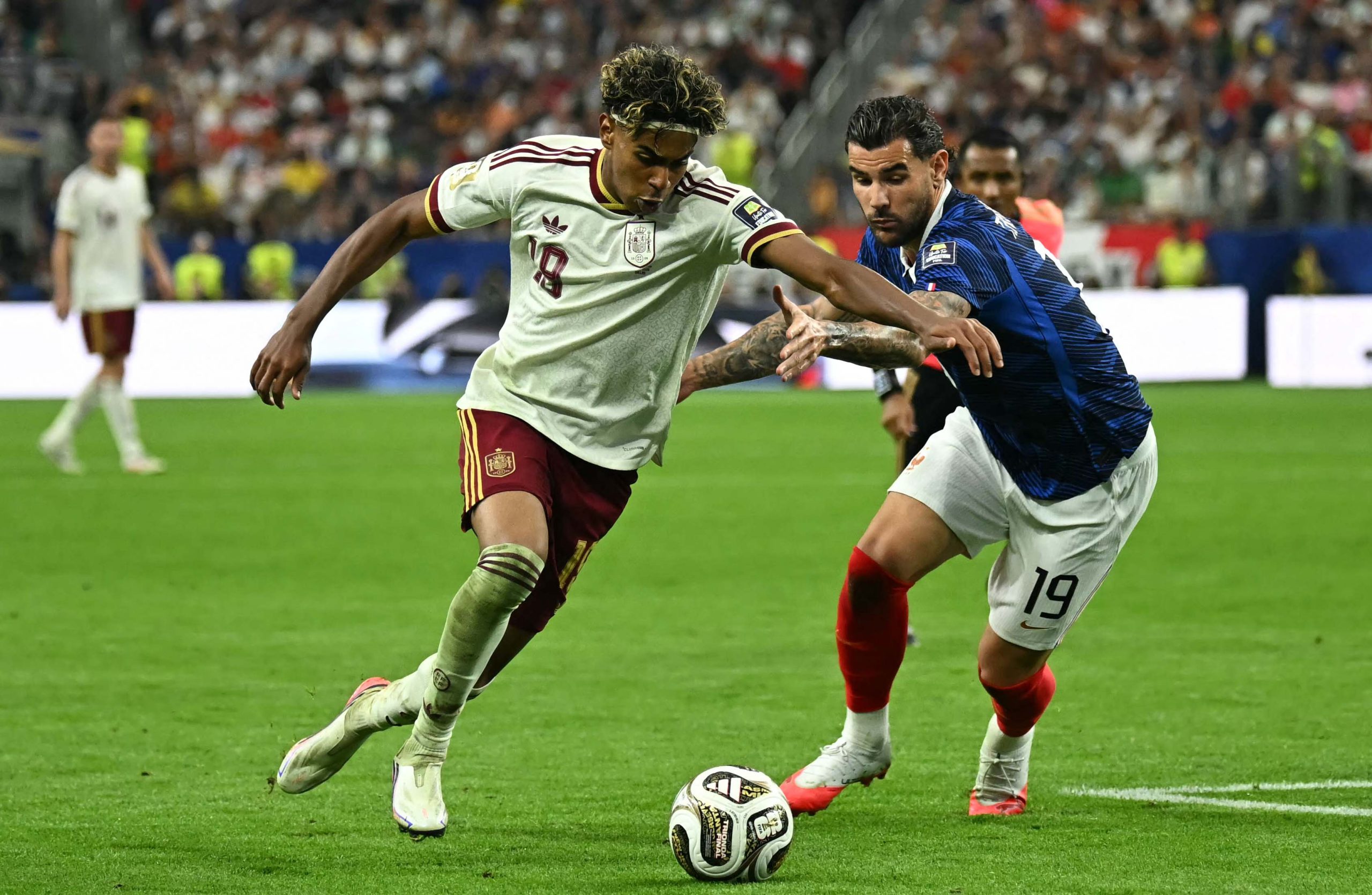 Lamine Yamal (left) attempts to get past France defender Theo Hernandez
