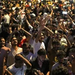 Demonstrators celebrate the resignation of India's Education Minister Dharmendra Pradhan