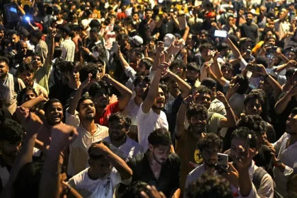 Demonstrators celebrate the resignation of India's Education Minister Dharmendra Pradhan