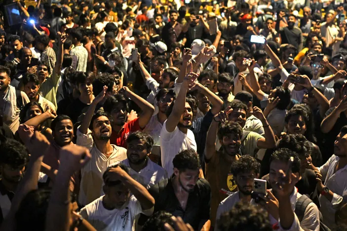 Demonstrators celebrate the resignation of India's Education Minister Dharmendra Pradhan