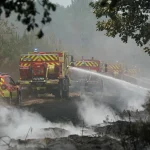 Firefighters extinguish remaining hotspots and smoldering areas