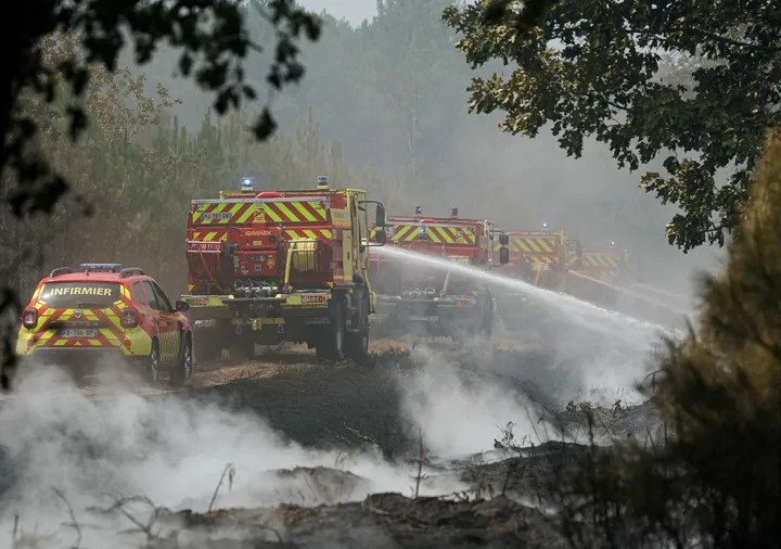 Firefighters extinguish remaining hotspots and smoldering areas