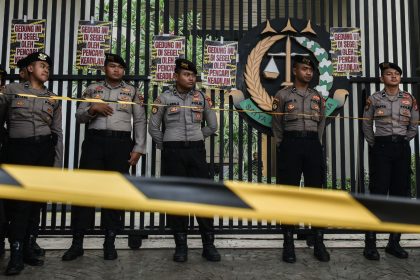 Police officers stand guard